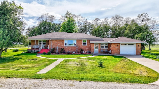 2651 E 2900 N Rd, Ancona, IL 61311 - view of front of property featuring a porch, a garage, brick siding, a front yard, and driveway