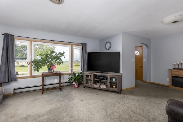 2651 E 2900 N Rd, Ancona, IL 61311 - carpeted living room featuring a baseboard radiator, arched walkways, baseboards, and a glass covered fireplace