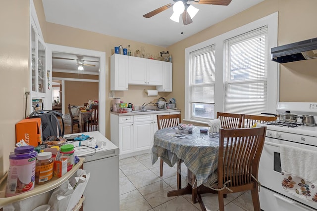 kitchen with gas range gas stove, ceiling fan, light countertops, and white cabinets