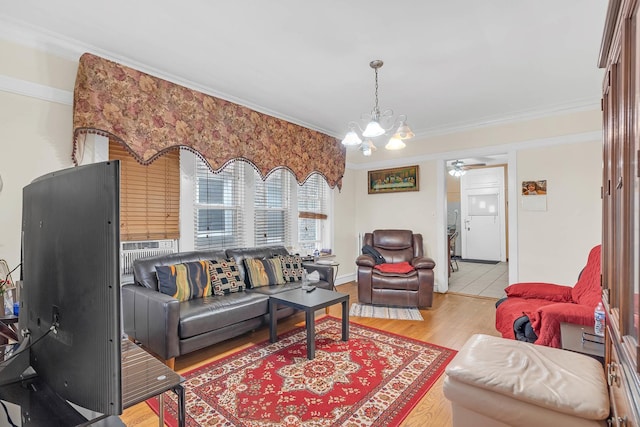 living room featuring crown molding, a chandelier, wood finished floors, and a ceiling fan