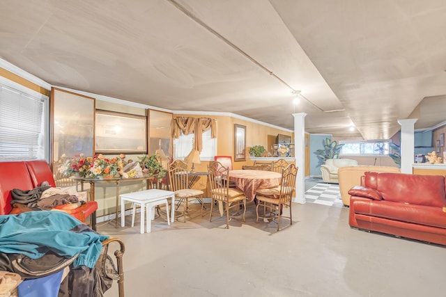 dining space featuring decorative columns, concrete floors, and crown molding