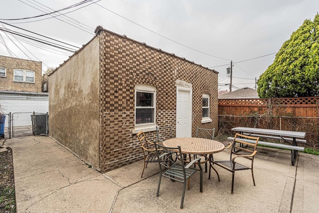 view of patio featuring outdoor dining area and fence