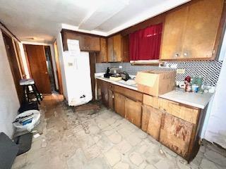 7502 W 64th St, Summit, IL 60501 - kitchen featuring decorative backsplash, light countertops, and freestanding refrigerator