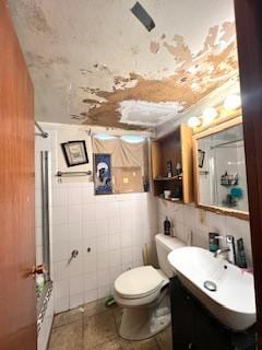 7502 W 64th St, Summit, IL 60501 - bathroom featuring tile walls, toilet, and vanity
