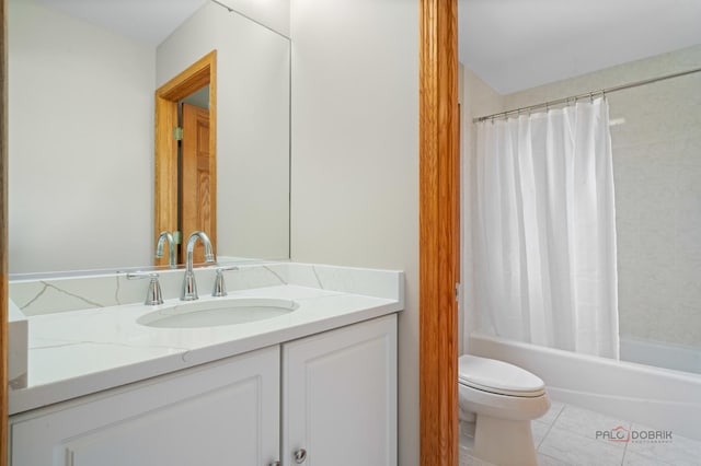 full bath featuring toilet, tile patterned floors, shower / bath combo, and vanity