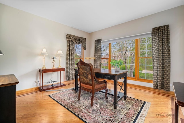 home office featuring wood finished floors and baseboards