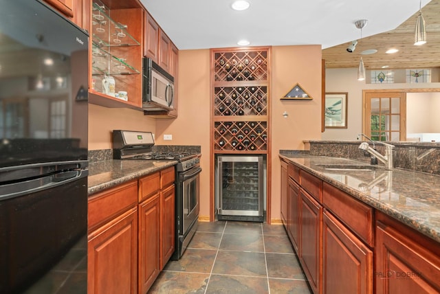 kitchen with stainless steel appliances, wine cooler, recessed lighting, a sink, and dark stone countertops