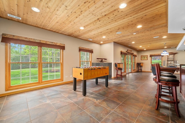 recreation room featuring recessed lighting, wooden ceiling, baseboards, and dark tile patterned floors