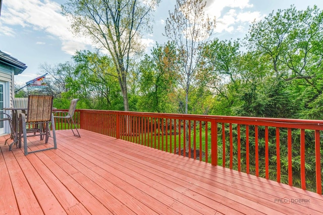 wooden terrace featuring outdoor dining area