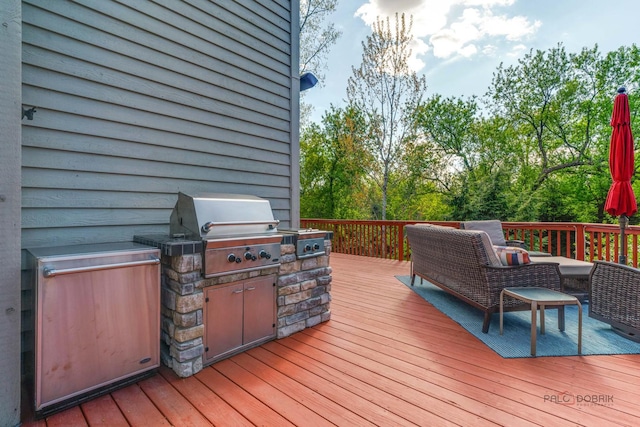 wooden terrace with grilling area, exterior kitchen, and an outdoor living space