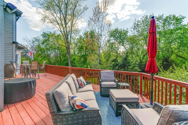 wooden terrace with an outdoor hangout area and outdoor dining area