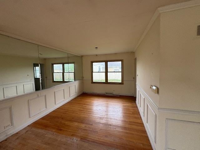 8135 W Rascher Ave, Chicago, IL 60656 - empty room featuring a decorative wall, wood finished floors, and a wainscoted wall