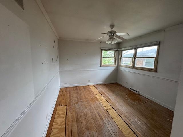 8135 W Rascher Ave, Chicago, IL 60656 - unfurnished room featuring light wood-style floors, a ceiling fan, and baseboards