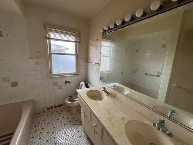 8135 W Rascher Ave, Chicago, IL 60656 - full bath featuring tile walls, tile patterned floors, a bath, wainscoting, and toilet