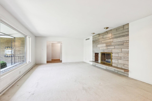 unfurnished living room featuring carpet flooring and a stone fireplace