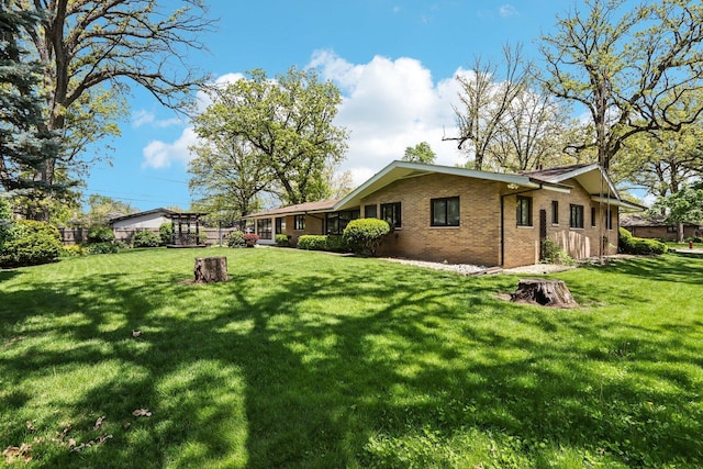 view of side of home with a lawn and brick siding