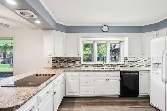 kitchen featuring black appliances, a sink, backsplash, white cabinets, and dark wood-style floors