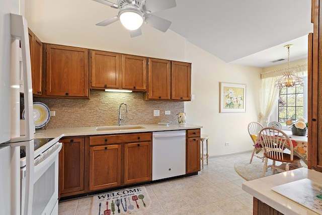 kitchen with white appliances, a sink, lofted ceiling, light countertops, and backsplash