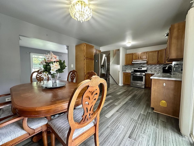 815 S Oak St, West Chicago, IL 60185 - dining space featuring dark wood finished floors and a chandelier