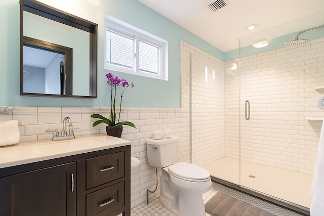 5127 S Artesian Ave, Chicago, IL 60632 - bathroom featuring tile walls, vanity, a shower stall, and tile patterned flooring