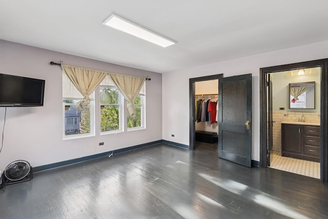 5127 S Artesian Ave, Chicago, IL 60632 - unfurnished bedroom featuring dark wood-style flooring, a walk in closet, a closet, and ensuite bath