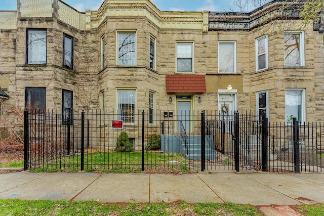 6602 S Marquette Ave, Chicago, IL 60637 - view of property featuring stone siding and a fenced front yard