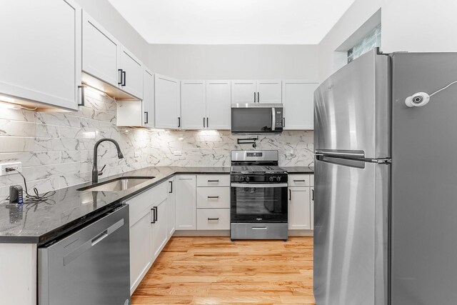 6602 S Marquette Ave, Chicago, IL 60637 - kitchen with stainless steel appliances, a sink, and white cabinetry