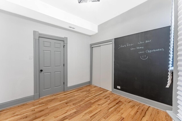 6602 S Marquette Ave, Chicago, IL 60637 - unfurnished bedroom with light wood-type flooring and a closet