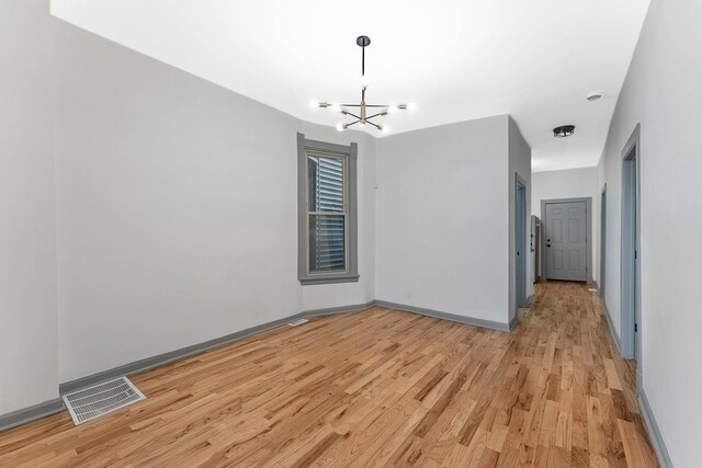 6602 S Marquette Ave, Chicago, IL 60637 - unfurnished dining area featuring light wood-type flooring, a chandelier, and baseboards
