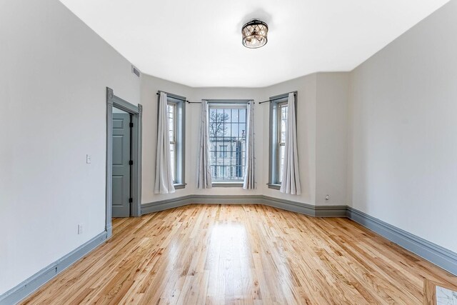6602 S Marquette Ave, Chicago, IL 60637 - empty room with wood finished floors and baseboards