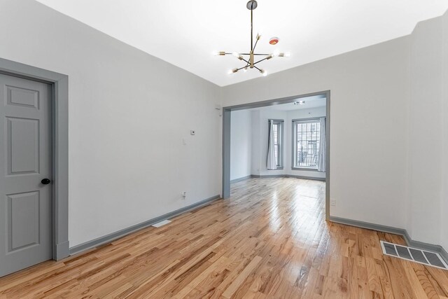 6602 S Marquette Ave, Chicago, IL 60637 - unfurnished dining area with a chandelier, light wood-style floors, and baseboards