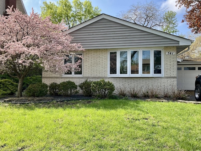 741 E Division St, Lombard, IL 60148 - view of property exterior featuring brick siding, an attached garage, and a yard