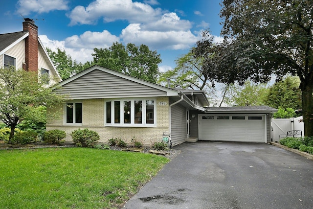 741 E Division St, Lombard, IL 60148 - view of front of house with asphalt driveway, a garage, a front yard, and brick siding