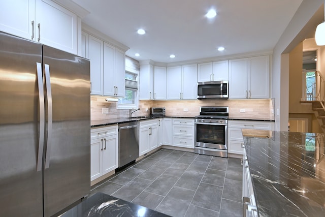 741 E Division St, Lombard, IL 60148 - kitchen with appliances with stainless steel finishes, tasteful backsplash, white cabinets, dark stone countertops, and recessed lighting