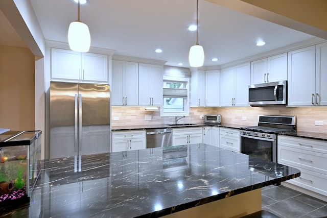 741 E Division St, Lombard, IL 60148 - kitchen with appliances with stainless steel finishes, tasteful backsplash, white cabinets, dark stone counters, and recessed lighting