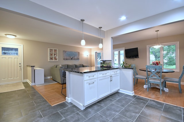 741 E Division St, Lombard, IL 60148 - kitchen featuring dark countertops, open floor plan, white cabinetry, pendant lighting, and baseboards