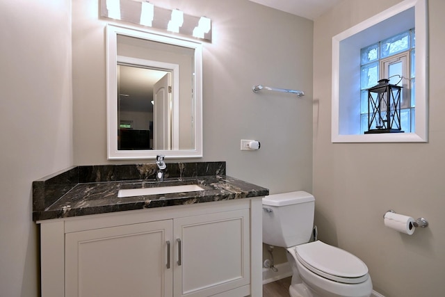 741 E Division St, Lombard, IL 60148 - half bath featuring toilet, vanity, and baseboards