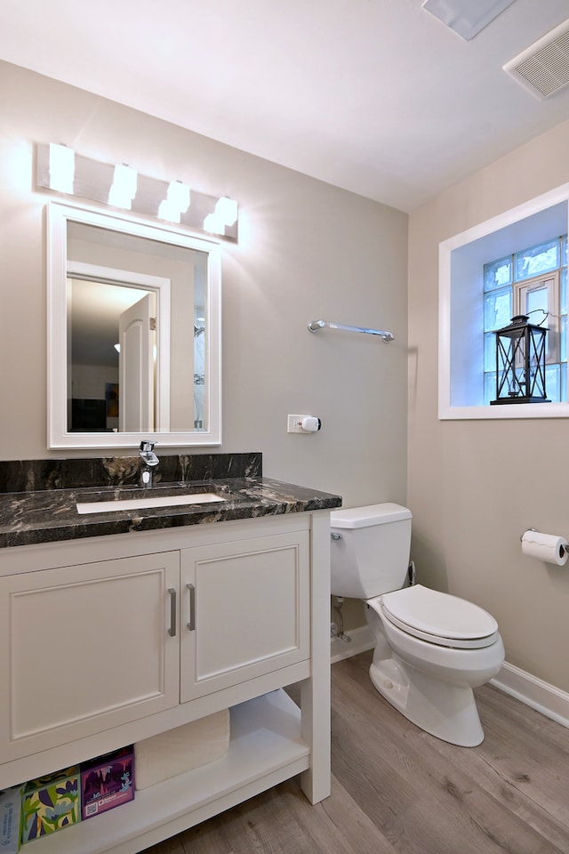 741 E Division St, Lombard, IL 60148 - bathroom featuring toilet, wood finished floors, baseboards, and vanity