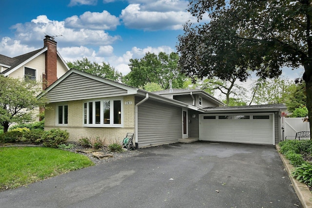741 E Division St, Lombard, IL 60148 - view of front of house with driveway, brick siding, and an attached garage
