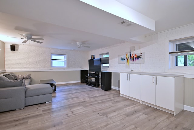 741 E Division St, Lombard, IL 60148 - living room with plenty of natural light, light wood finished floors, ceiling fan, and brick wall