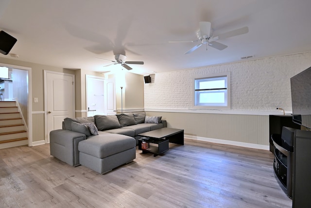 741 E Division St, Lombard, IL 60148 - living room featuring ceiling fan, stairs, light wood finished floors, and a wainscoted wall