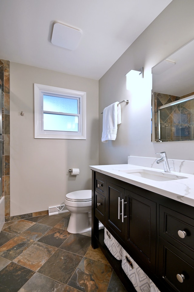741 E Division St, Lombard, IL 60148 - full bath with a tile shower, vanity, toilet, and stone tile floors