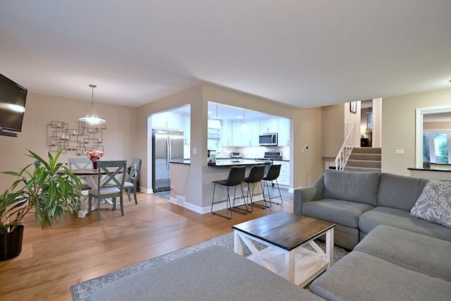 741 E Division St, Lombard, IL 60148 - living room with light wood-type flooring, stairs, and baseboards