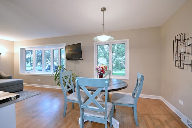 741 E Division St, Lombard, IL 60148 - dining area with plenty of natural light, light wood-style floors, and baseboards