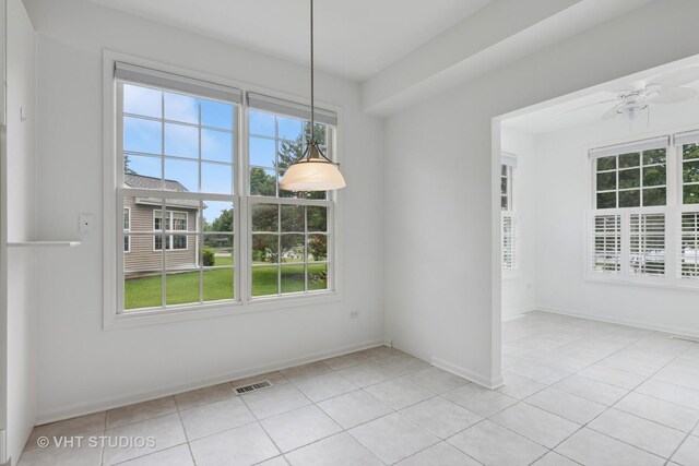 16306 Windsor Lake Ct, Crest Hill, IL 60403 - unfurnished dining area featuring light tile patterned floors, ceiling fan, and baseboards
