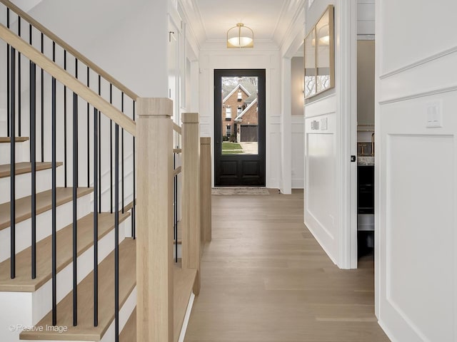 228 S Adams St, Hinsdale, IL 60521 - foyer entrance with a decorative wall, wood finished floors, stairway, crown molding, and wainscoting