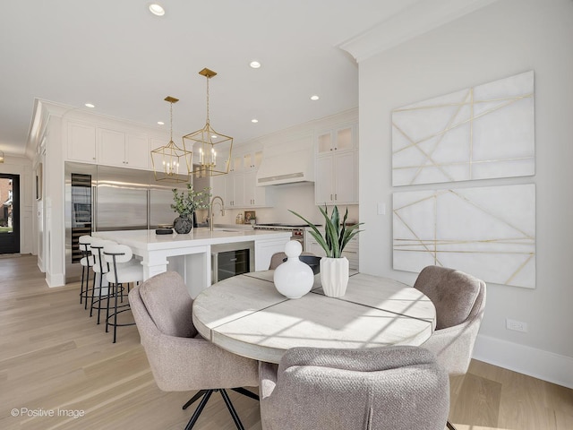 228 S Adams St, Hinsdale, IL 60521 - dining space with a chandelier, beverage cooler, light wood-type flooring, baseboards, and recessed lighting