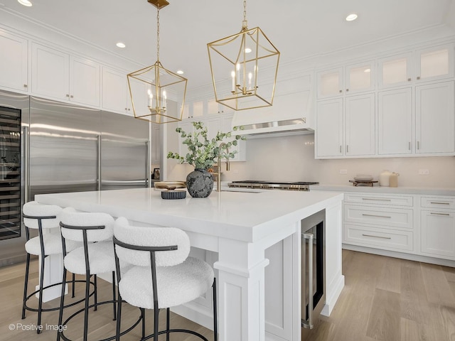 228 S Adams St, Hinsdale, IL 60521 - kitchen featuring white cabinets, a sink, a kitchen island, recessed lighting, and light countertops