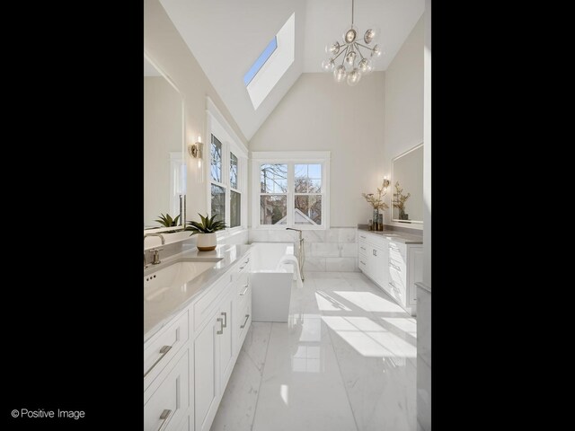 228 S Adams St, Hinsdale, IL 60521 - full bath with marble finish floors, vanity, a freestanding bath, a chandelier, and high vaulted ceiling