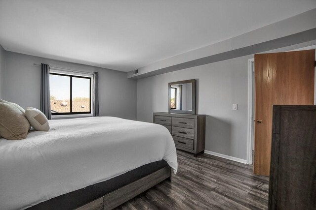 463 Valley Dr Unit 303, Naperville, IL 60563 - bedroom featuring dark wood-style flooring and baseboards